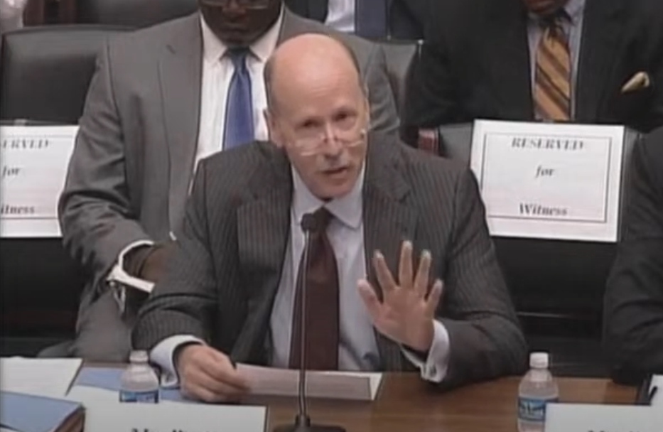 Stuart Pratt sits with a microphone in front of him as he testifies before the 2014 House Subcommittee.